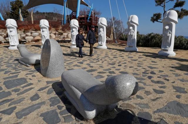 Tourists look at statues in South Korea's Haeshindang Park, also know as "penis park", a shrine to fertility dedicated to the legend of a local girl who died a virgin, in Sinnam, South Korea, February 12, 2018. Picture taken February 12, 2018. REUTERS/Eric Gaillard.