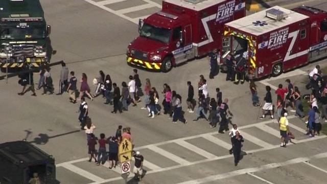 Students are evacuated from Marjory Stoneman Douglas High School during a shooting incident in Parkland, Florida, U.S. February 14, 2018 in a still image from video. WSVN.com via REUTERS