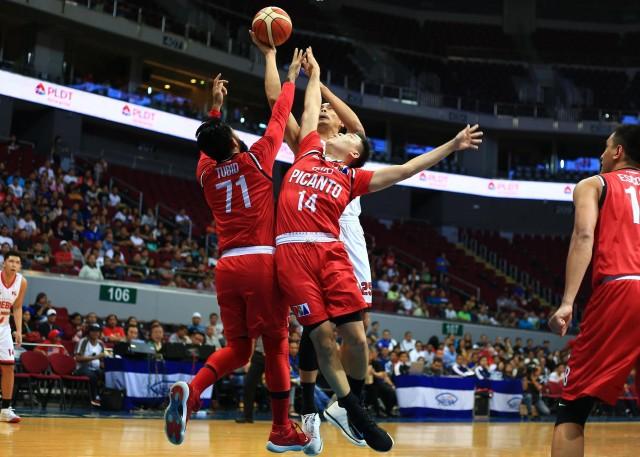 Japeth Aguilar of Ginebra forces his shot against two defenders of KIA during the 43rd PBA Philippine Cup in MOA Arena on Wednesday. PHOTO BY KC Cruz