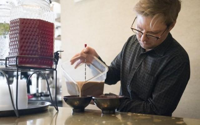 Harding Stowe pours Kava into a bowl to be served at Brooklyn Kava January 18, 2018 in New York. DON EMMERT / AFP