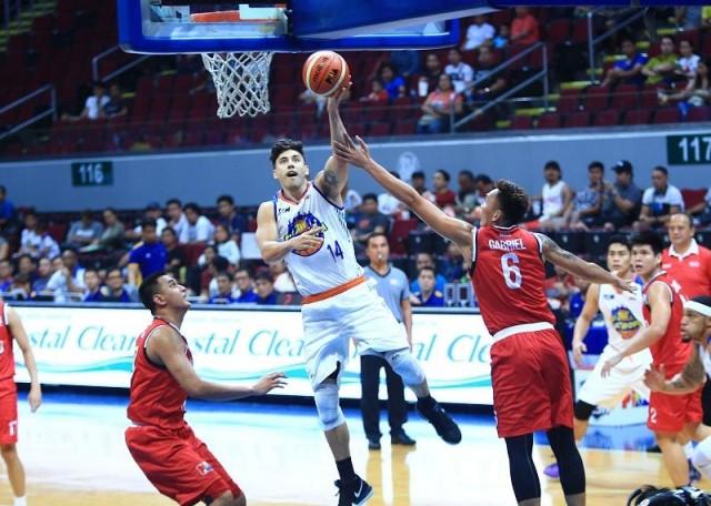 Tony Semerad of TNT goes for a layup against Jonjon Gabriel of KIA during their game in the 43rd PBA Philippine Cup in MOA Arena on Wednesday. Photo: KC Cruz