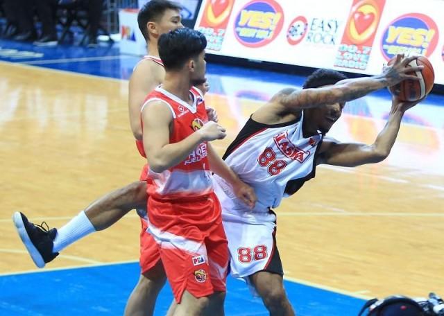 Calvin Abueva of Alaska loss his balance when getting the rebound against two defenders of Phoenix during their game in the 43rd PBA Philippine Cup in MOA Arena on Wednesday. Photo: KC Cruz