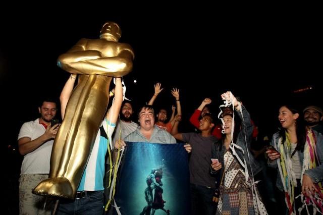 Fans of Mexican director Guillermo del Toro celebrate at La Minerva square, in Guadalajara, Jalisco State, on March 4, 2018, after del Toro won the Oscar for "The Shape of Water." Ulises Ruiz/AFP