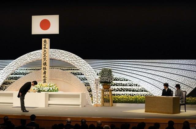 Japanese Prime Minister Shinzo Abe bows to Prince Akishino and Princess Kiko in Tokyo on March 11, 2018 during the seventh national memorial service for victims of the disaster. Shizuo Kambayashi/Pool/AFP