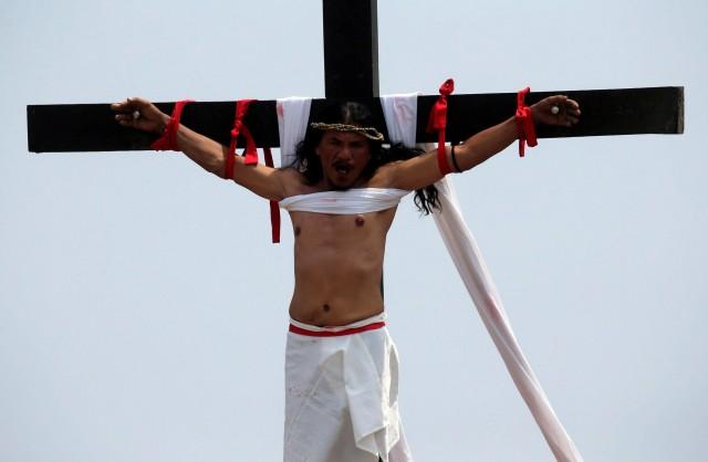 Ruben Enaje, 58, seen here being raised on a wooden cross on Good Friday in Barangay Cutud, said he felt 'great' after his 32nd annual crucifixion in Pampanga. REUTERS/Romeo Ranoco