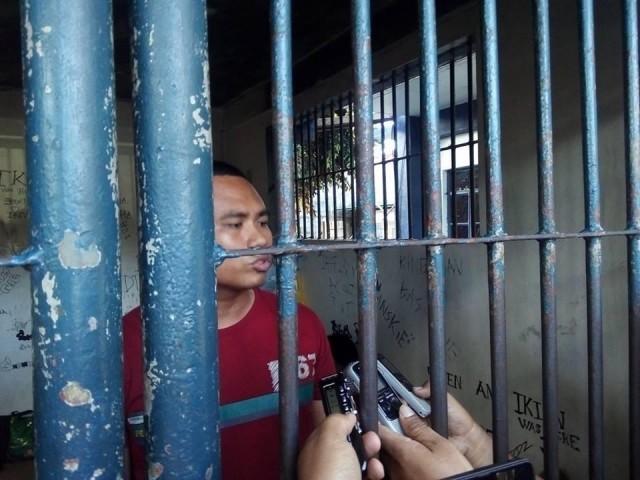 Security Guard Adelfo Estilloso is detained at the Dumaguete City Police Station after he shot his co-worker, Gustavo Catubay, allegedly over a joke. PHOTO BY SYRIL REPE