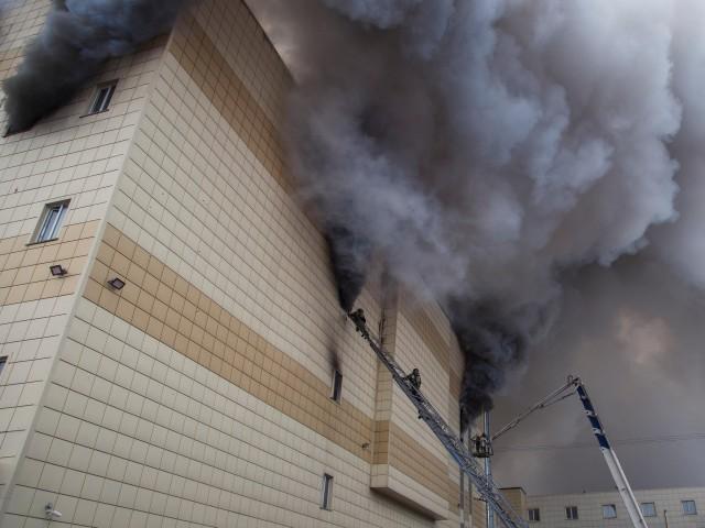 Members of the Emergency Situations Ministry work to extinguish a fire in a shopping mall in the Siberian city of Kemerovo, Russia March 25, 2018. Picture taken March 25, 2018. REUTERS/Marina Lisova