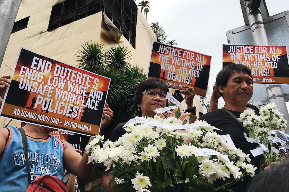 Militant workers from the Kilusang Mayo Uno on Thursday, March 22, 2018, demanded justice for the victims of Manila Pavilion Hotel and Casino fire during a memorial program held in front of the gutted hotel. The group offered flowers in honor of the six employees of the Philippine Amusement and Gaming Corp. who perished in the blaze, which lasted for over 24 hours. Jun Veneracion