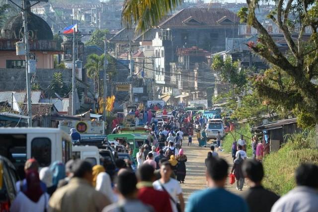 Thousands of residents wait to pass through a military check point after authorities allowed them to visit their destroyed houses at the main battle area in Marawi City on April 1, 2018. Ted Aljibe/AFP