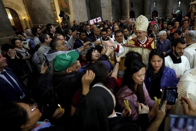 The head of the Roman Catholic Church in the Holy Land, Apostolic Administrator of the Latin Patriarchate Pierbattista Pizaballa, leads the Easter Sunday procession on April 1, 2018 at the Church of the Holy Sepulchre, traditionally believed to be the site of Christ's crucifixion and resurrection, in the old city of Jerusalem. Gali Tibbon/AFP