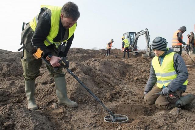Amateur archaeologist Rene Schoen and 13-year-old student Luca Malaschnichenko look for a treasure with a metal detector in Schaprode, northern Germany on April 13, 2018. The pair have unearthed a "significant" trove in Germany which may have belonged to the legendary Danish king Harald Bluetooth who brought Christianity to Denmark. Stefan Sauer/dpa/AFP