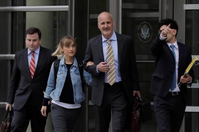 Actress Allison Mack, known for her role in the TV series "Smallville", departs after being granted bail following being charged with sex trafficking and conspiracy in New York, U.S., April 24, 2018. REUTERS/Lucas Jackson