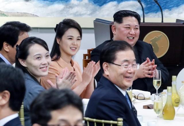 North Korean leader Kim Jong Un applauds with his wife Ri Sol Ju and sister Kim Yo Jong at the truce village of Panmunjom inside the demilitarized zone separating the two Koreas, South Korea, April 27, 2018. Korea Summit Press Pool/Pool via Reuters