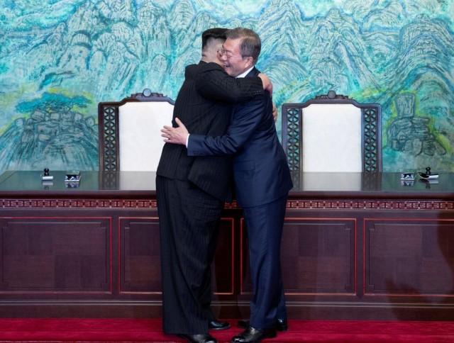 South Korean President Moon Jae-in and North Korean leader Kim Jong Un embrace at the truce village of Panmunjom inside the demilitarized zone separating the two Koreas, South Korea, April 27, 2018. Korea Summit Press Pool/Pool via Reuters