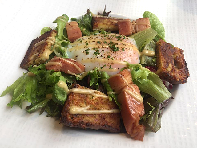 Lyon-style salad served with a cake of pigâ€™s ears