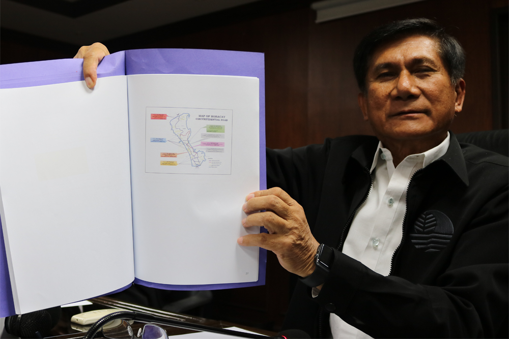 Environment Secretary Roy Cimatu on Friday, April 6, 2018, shows a map of the proposed road improvements in Boracay. Aya Tantiangco