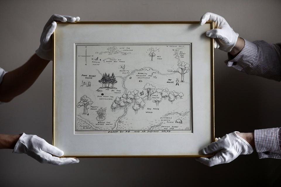 Sotheby's staff hold the original map of Winnie the Pooh's Hundred Acre Wood by E.H. Shepard at Sotheby's auction rooms in London, Britain, May 31, 2018. REUTERS/Simon Dawson