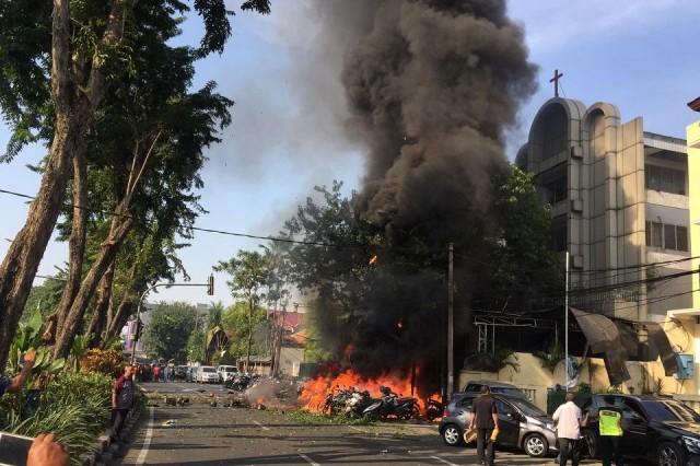 Motorcycles burn following a blast at the Pentecost Church Central Surabaya (GPPS), in Surabaya, East Java, Indonesia May 13, 2018, in this photo provided by Antara Foto. Antara Foto/ Handout Surabaya Government/ via REUTERS