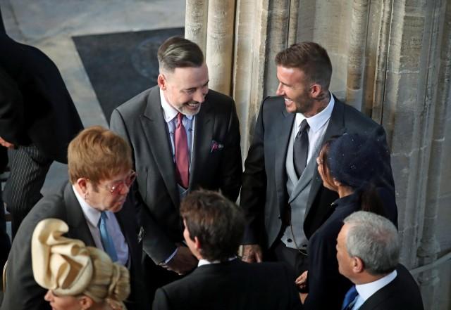 David and Victoria Beckham talk with Sir Elton John and David Furnish as they arrive in St George's Chapel at Windsor Castle.