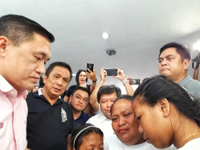 Sestoso's bereaved widow Lourdes and daughters Eden and Bernadeth are omforted by (from left) Go, Negros Oriental Governor Roel Degamo, Dumaguete Mayor Felipe Remollo, and Communications Secretary Martin Andanar. Photo: Raffy Cabristante