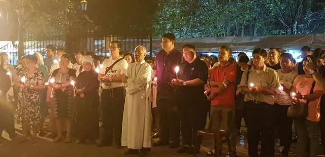 Diocese of Bacolod Bishop Patricio Buzon leads at least 200 people in lighting candles to show indignation over the ouster of Chief Justice Maria Lourdes Sereno. The prayer rally was held in front of San Sebastian Cathedral in Bacolod City Friday night. CONTRIBUTED PHOTO