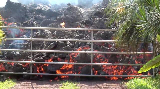 Lava advances towards a metal barrier in Puna, Hawaii, U.S., May 6, 2018 in this still image obtained from social media video. WXCHASING via REUTERS