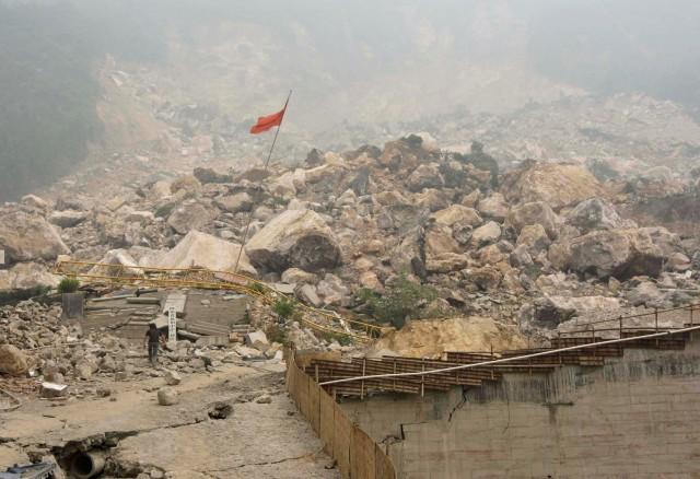A man walks towards Beichuan Middle School which was buried under boulders before people were ordered to evacuate from the center of earthquake-hit Beichuan county, Sichuan province, China, May 17, 2008. REUTERS/Jason Lee/File Photo