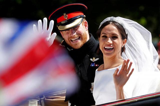 Britain's Prince Harry and his wife Meghan wave as they ride a horse-drawn carriage after their wedding ceremony at St. George's Chapel in Windsor Castle in Britain on Saturday, May 19, 2018. Reuters/Damir Sagolj