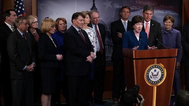 US Senators Claire McCaskill (third from left) and Joe Manchin (second from right) listen during a news conference February 15, 2018 at the Capitol in Washington, DC. McCaskill on monday thanked Manchin for saving her from choking last week. Alex Wong/Getty Images North America/AFP