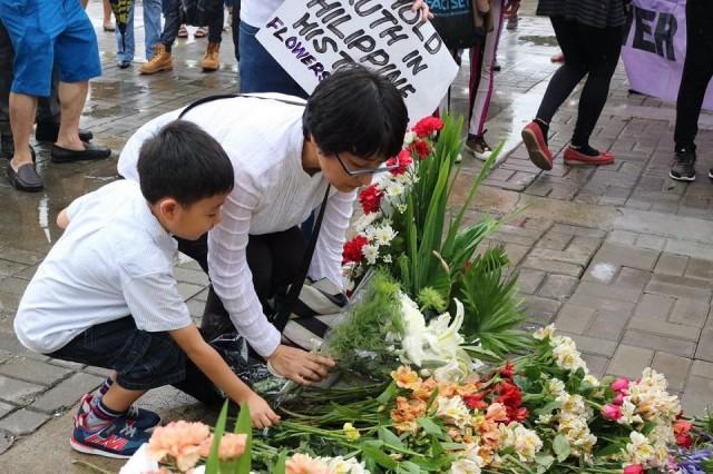 Naoko Okimoto lays flowers at the site where a comfort woman statue once stood, during the launch of the #Flowers4Lola campaign, which aims to spread awareness of the atrocities suffered by Filipino women during World War II. Aya Tantiangco