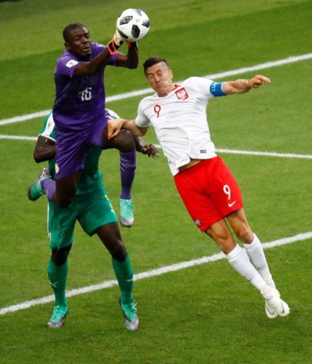 World Cup - Group H - Poland vs Senegal - Spartak Stadium, Moscow, Russia - June 19, 2018 Senegal's Khadim N'Diaye in action with Poland's Robert Lewandowski REUTERS/Kai Pfaffenbach