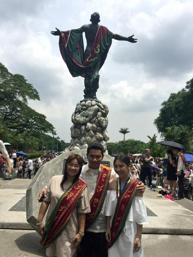 Lorelei, Mark Romeo and Lorielle Ann pose behind the UP Oblation on their graduation day.