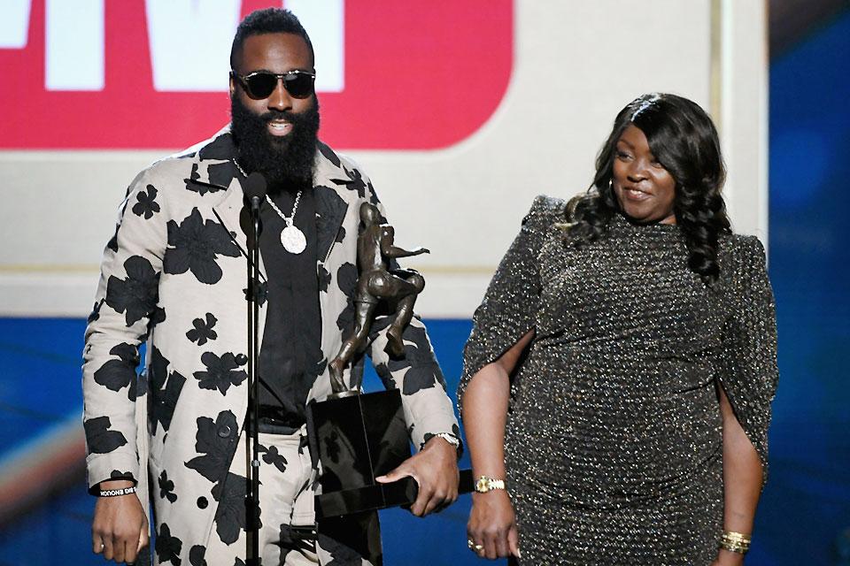 James Harden (left), along with Monja Willis, holds his MVP trophy while speaking onstage at the 2018 NBA Awards at Barkar Hangar in Santa Monica, California on Monday, June 25, 2018. Kevin Winter/Getty Images for Turner Sports/AFP 