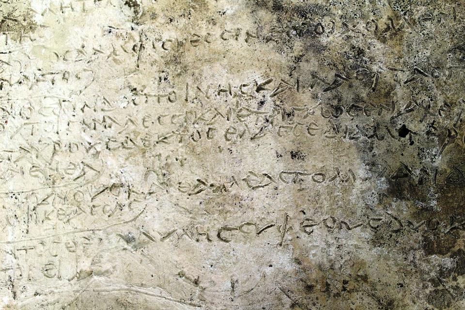 An undated handout picture released by the Greek Culture Ministry shows a clay plaque discovered in Ancient Olympia with an engraved inscription depicting thirteen verses from the Odyssey's 14th Rhapsody, in Ancient Olympia, Greece. Greek Culture Ministry/Handout via REUTERS