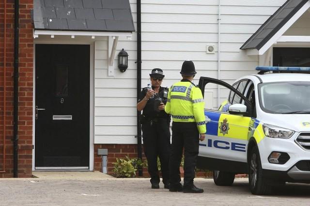 Police officers are seen outside a residential address in Amesbury, southern England, on July 4, 2018 where police reported a man and woman were found unconscious. They have been hospitalised in critical condition for exposure to an "unknown substance" in the same city where former Russian spy Sergei Skripal and his daughter were poisoned with a nerve agent earlier this year. Geoff Caddick/AFP