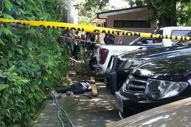 The body of an unidentified suspected gunman is seen at the parking lot of the Cebu Archbishop's Residence in Cebu City on Tuesday, July 10, 2018, after he was shot dead by police officers. The gunman reportedly was looking for Cebu Archbishop Jose Palma before the shootout. Photo courtesy: Councilor Dave Tumulak