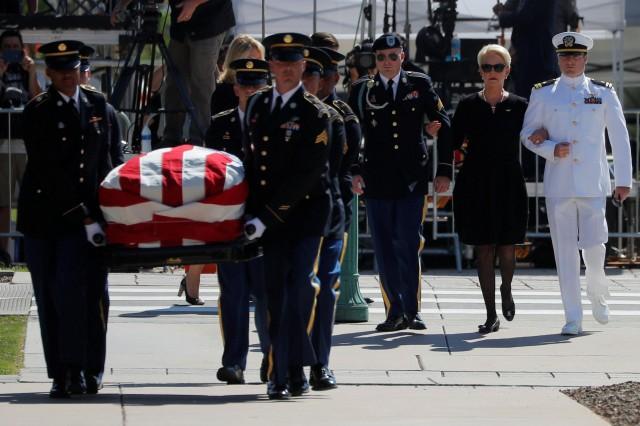 U.S. Senator John McCain's wife Cindy and their sons James (3rd R) and John (R) follow Senator McCain's casket into the Arizona State Capitol where he will lie in state in Phoenix, Arizona, U.S., August 29, 2018. REUTERS/Brian Snyder