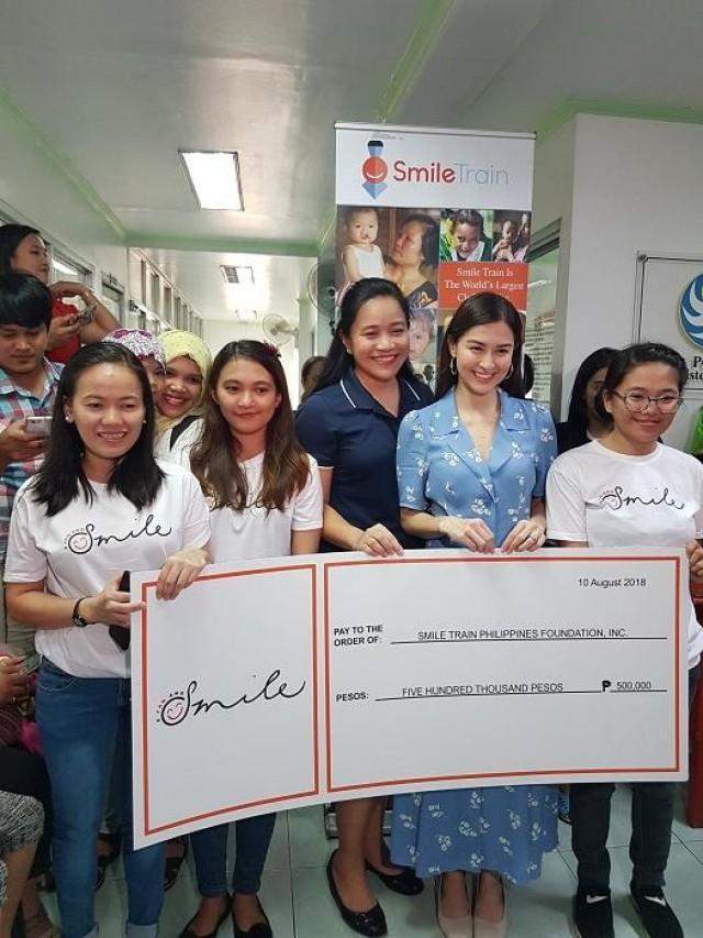 Marian donating the proceeds of her t-shirt initiative to Smile Train