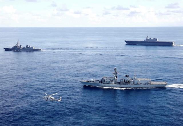 British frigate HMS Argyll (front), Japanese destroyer Inazuma (L) and Japanese helicopter carrier Kaga take part in a joint naval drill in the Indian Ocean, September 26, 2018. Picture taken September 26, 2018. REUTERS/Kim Kyung-Hoon