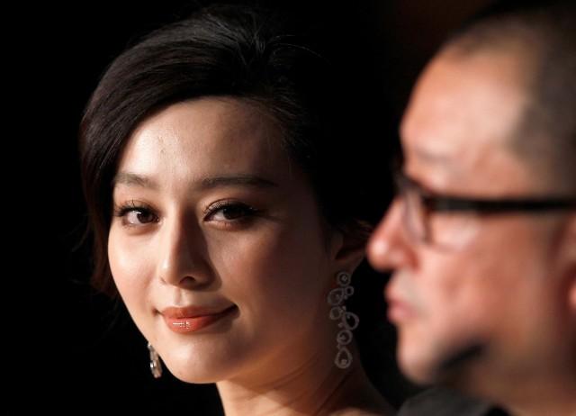 Director Wang Xiaoshuai (R) and cast member Fan Bingbing attend a news conference for the film "Rizhao Chongqing" at the 63rd Cannes Film Festival, France May 13, 2010. REUTERS/Yves Herman/File Photo