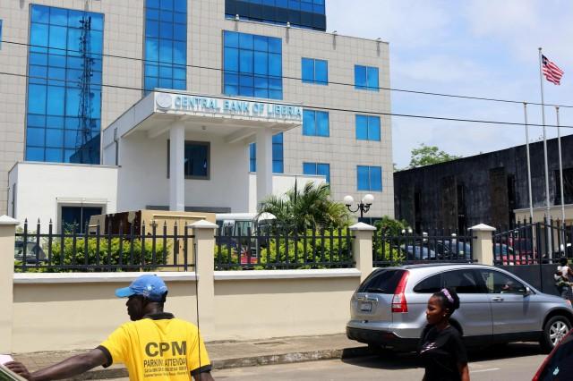 People walk outside the headquarters of the Central Bank of Liberia in Monrovia, Liberia September 19, 2018. REUTERS/James Giahyue