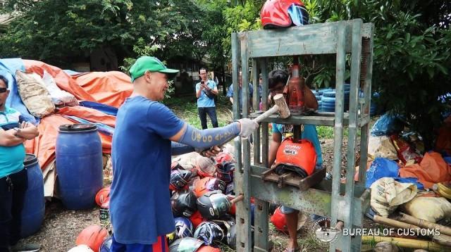 Customs personnel destroy forfeited goods in Angat, Bulacan on September 5, 2018. Photo: Bureau of Customs