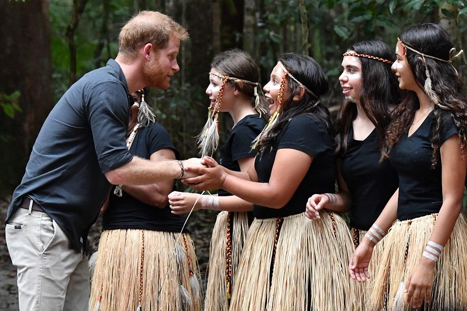 Britain's Prince Harry talks to members of the Butchulla people, who are the traditional owners of Fraser Island, during the unveiling of the Queen's Commonwealth Canopy plaque at Pile Valley on Fraser Island on October 22, 2018. Darren England/Pool/AFP