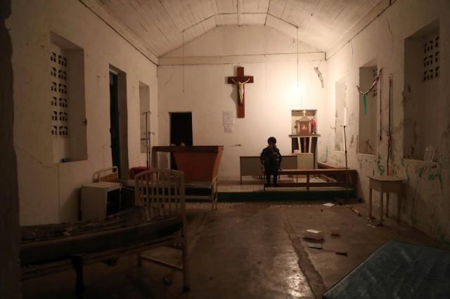 A woman sits inside the chapel of the hospital after an earthquake hit northern Haiti late on Saturday, in Port-de-Paix, Haiti, October 7, 2018. REUTERS/Ricardo Rojas