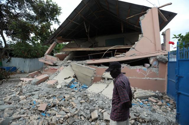 A man walks front of a school damaged in an earthquake, that hit northern Haiti late on Saturday, in Gros Morne, Haiti, October 8, 2018. REUTERS/Ricardo Rojas