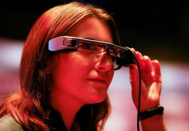 A person poses while wearing smart caption glasses designed by Epson, at the National Theater in London, Britain, October 3, 2018. REUTERS/Henry Nicholls