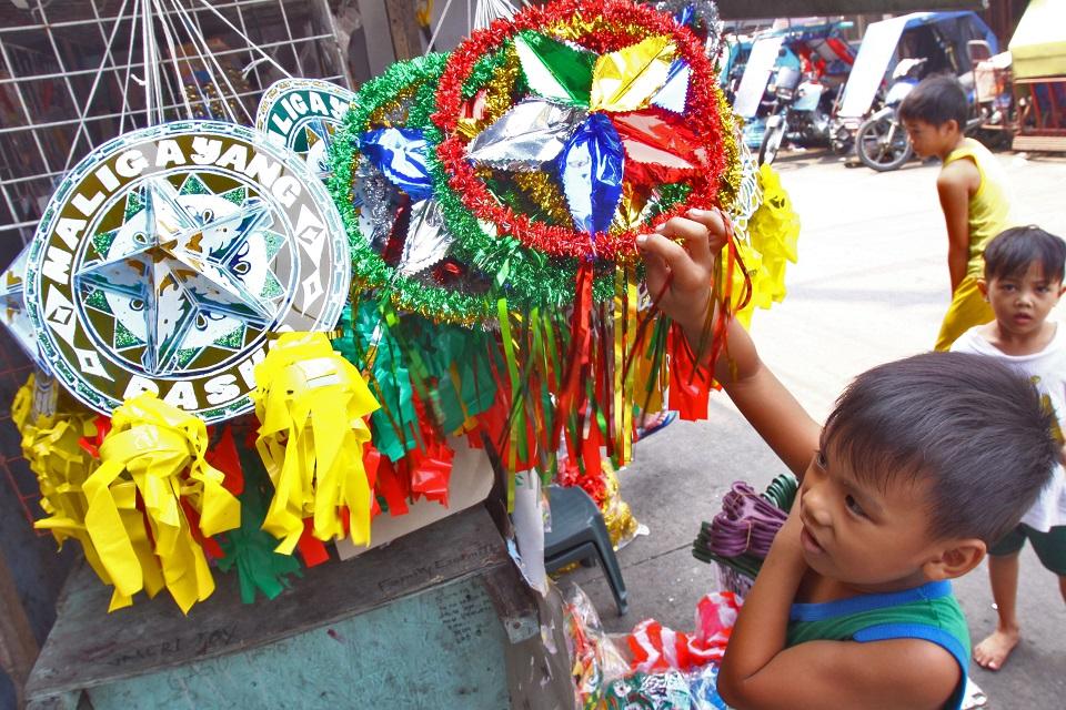 A child inspects Christmas lanterns selling for P20-P35 at Smokey Mountain in Tondo, Manila on Sunday, October 14, 2018. Store owners say consumers are spending less on Christmas decor amid high inflation. DANNY PATA