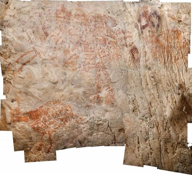 A handout photo released on November 7, 2018 by the Nature Publishing Group shows the world's oldest figurative artwork dated to a minimum of 40,000 years. The limestone caves of Borneoâ€™s East Kalimantan province contain thousands of rock art images, grouped into three phases: red-orange paintings of animals and hand stencils; younger, mulberry-coloured hand stencils and intricate motifs, alongside depictions of humans; and a final phase of human figures, boats and geometric designs in black pigment. Luc-Henri Fage/Kalimanthrope.com/Nature Publishing Group/AFP