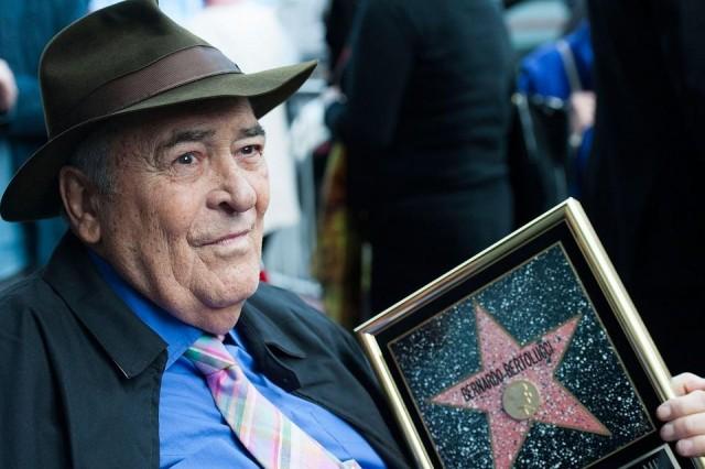 In this file photo taken on November 19, 2013 Italian director Bernardo Bertolucci celebrates his Star on the Hollywood Walk of Fame in Hollywood, California. Valerie Macon/Getty Images North America/AFP