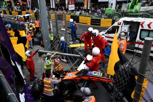 Race personnel and pit crew are seen at the accident site after Sophia Floersch, a German driver of Van Amersfoort Racing flew over the barriers and crashed into a photographers' bunker at high speed, during a Formula Three race at the Macau Grand Prix, in Macau, China November 18, 2018. Mai Shangmin/CNS via REUTERS